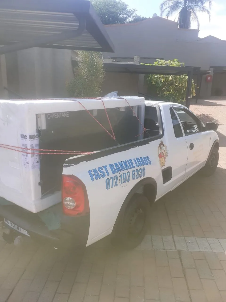 White chest freezer loaded on bakkie