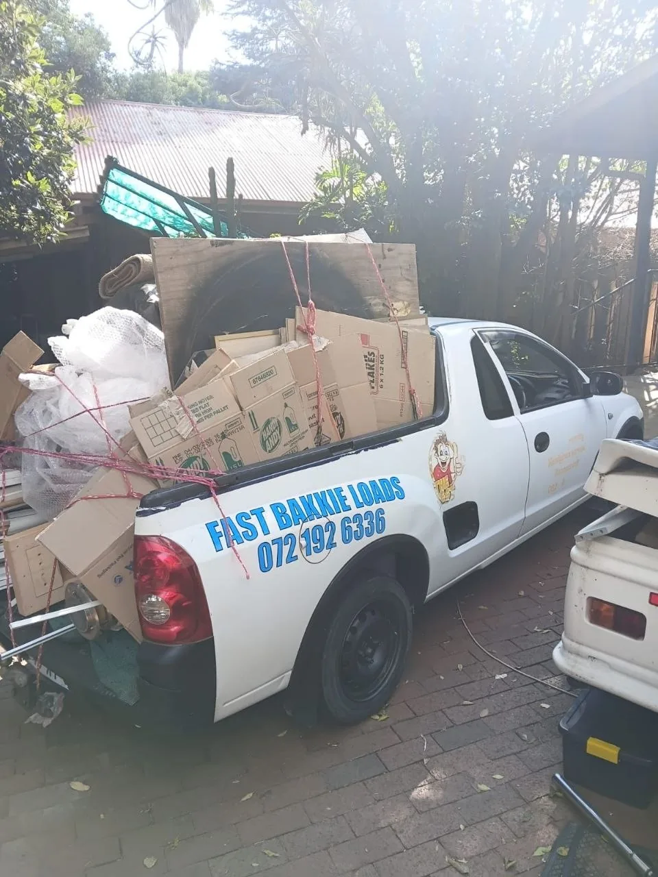 Cardboard boxes and household items in bakkie